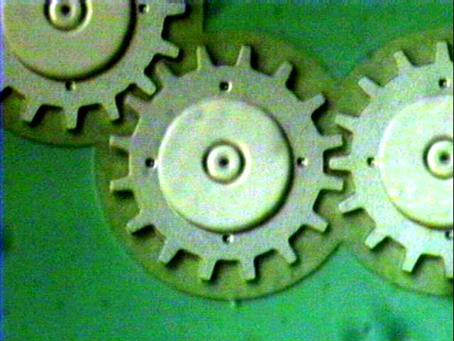 A gear with a radius of 40um (measured to mid-tooth). The gear teeth are 8um long and 4um wide at the outside.