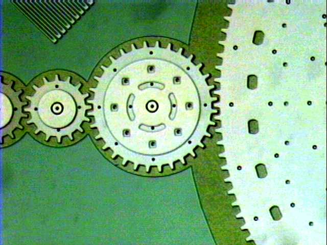 A gear with a radius of 80um (measured to mid-tooth). To the left are 40um radius gears and to the right is the edge of a 400um radius gear.