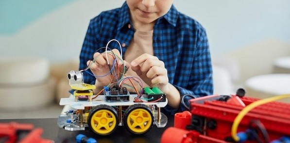 Student working with a robot