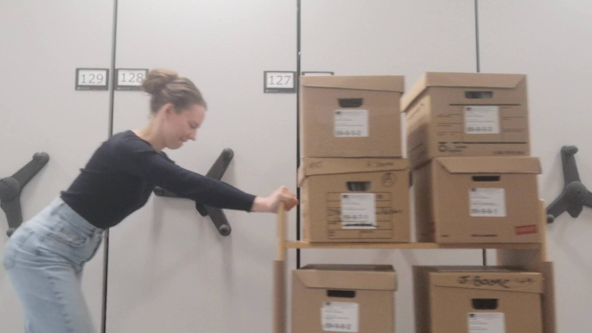 Kira Vandermeulen pushes boxes in the vault