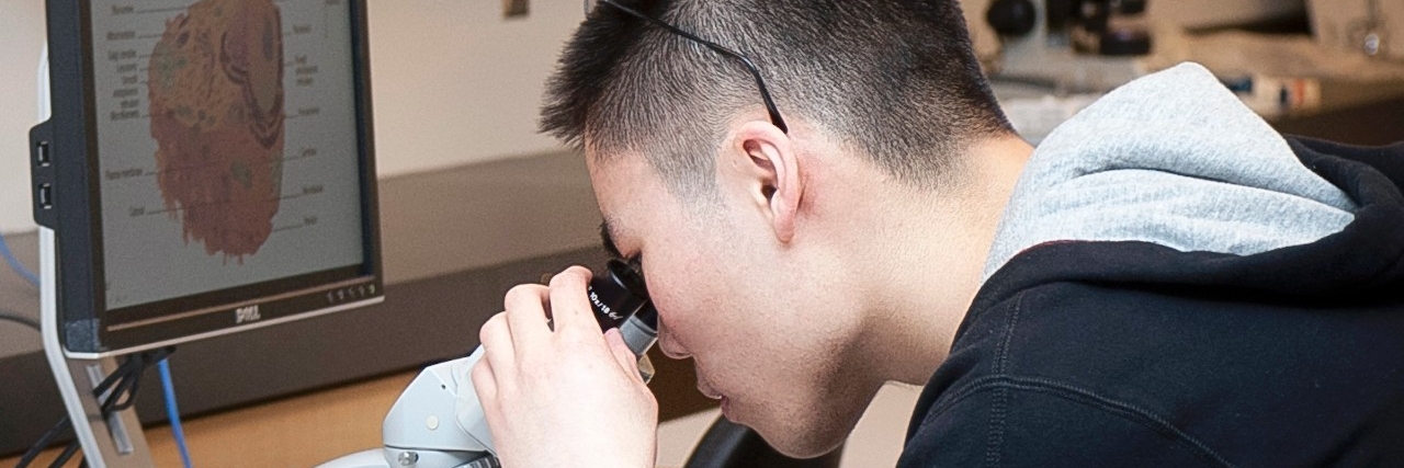 image of student with microscope