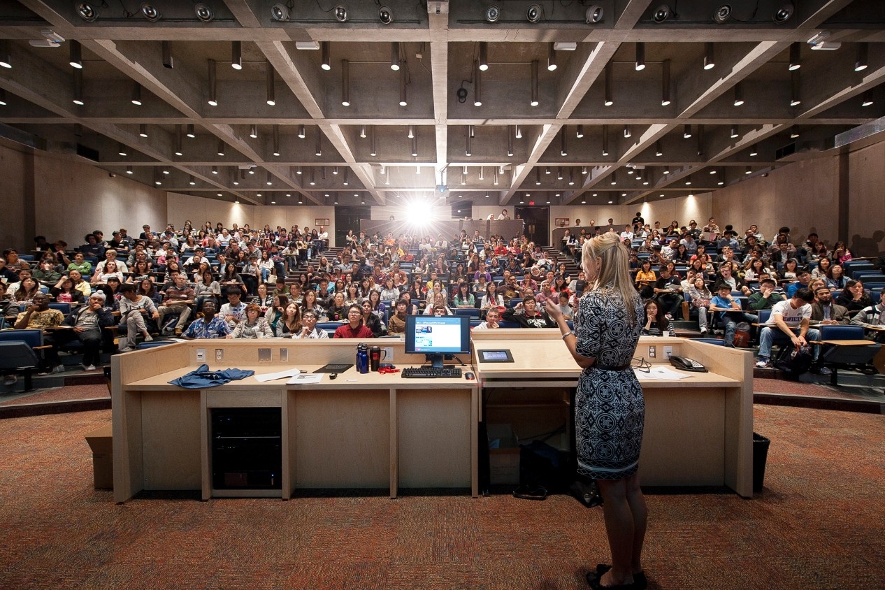 Picture of a woman speaking to a crowd in an auditorium
