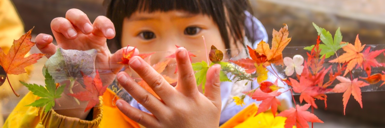Child engaging and hands on learning being outside in childcare class