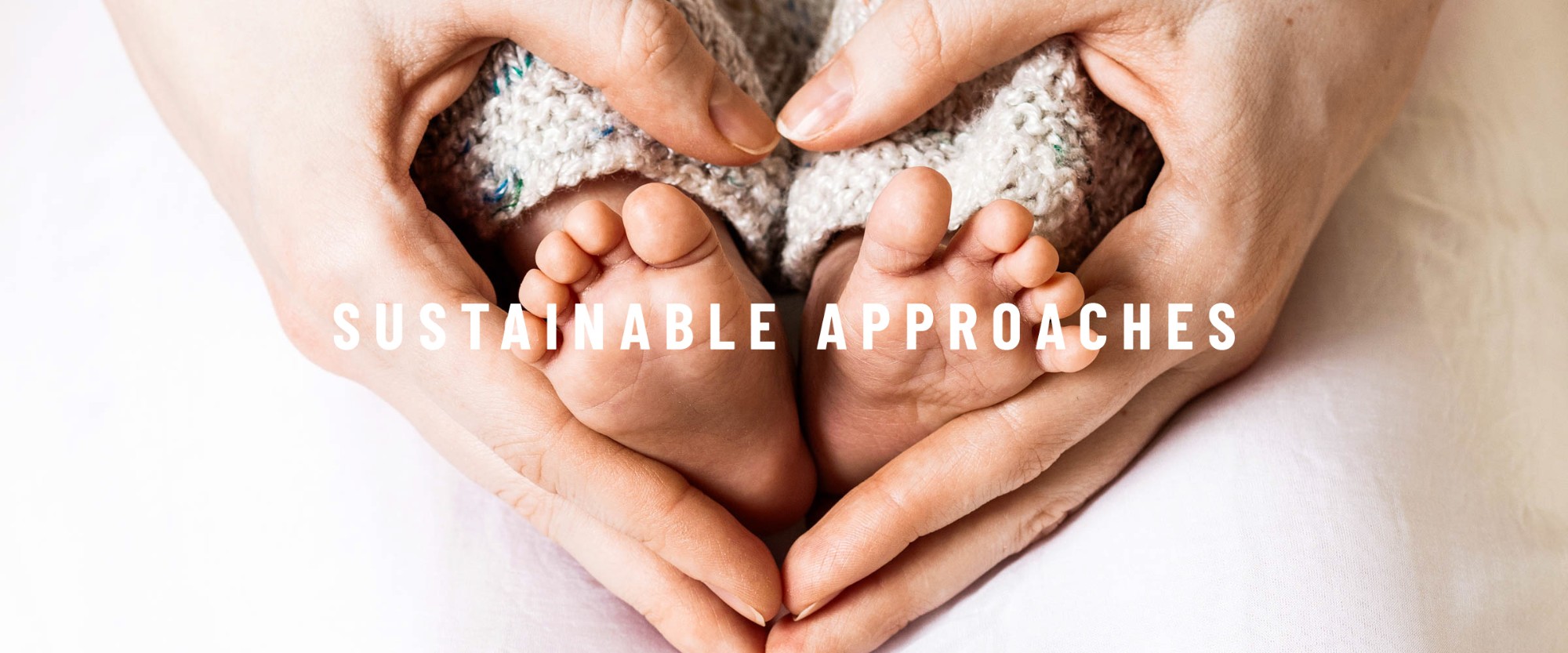 Image: Parent holding babies little feet Text: Sustainable approaches