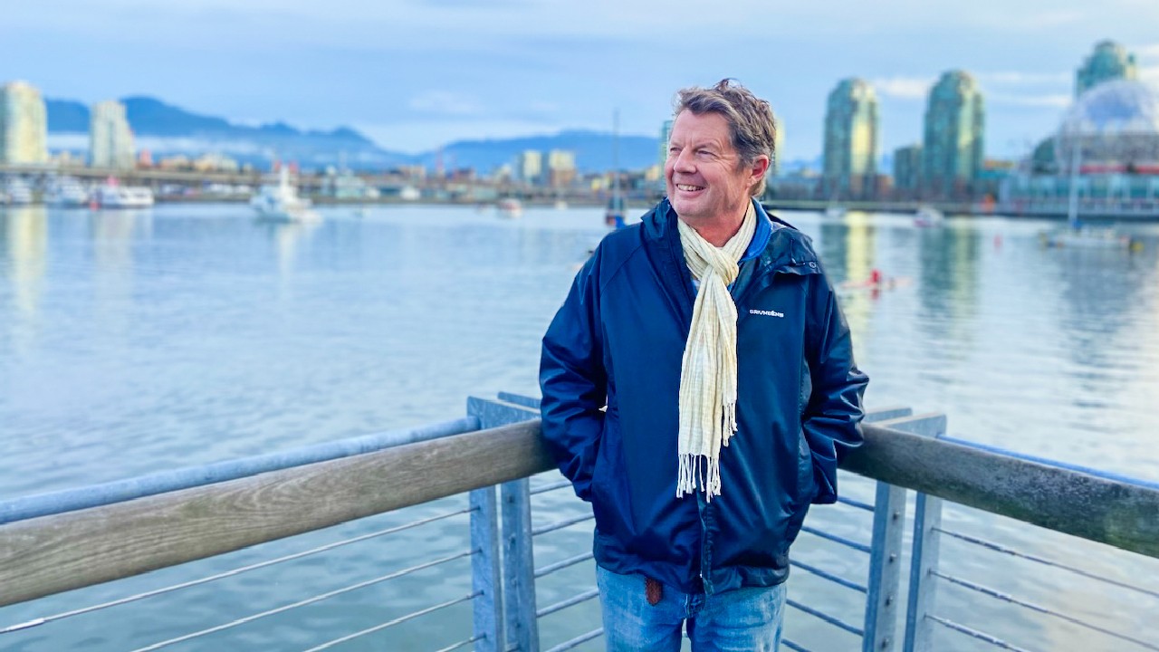 Dr. Nicholas Blomley posing at the waterfront of Vancouver downtown