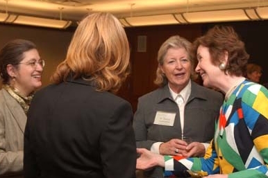 Mary Robinson speaking with three women at the leaders breakfast