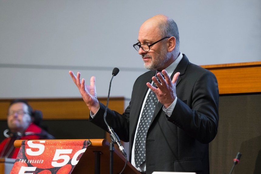 Tim Flannery speaking at the podium in the Asia Pacific Hall
