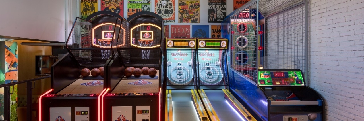 Image of the lower level of The Study. There are two basketball games, two skeeball games, and another arcade game.