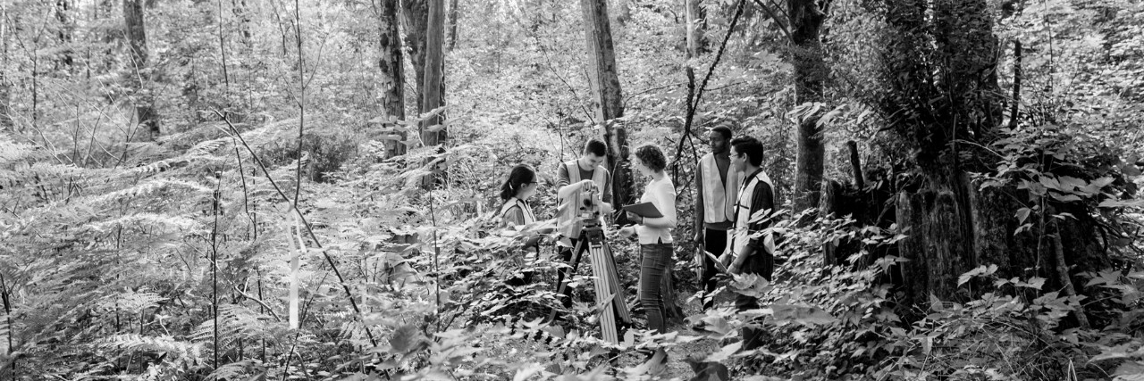 black and white image of students in forest