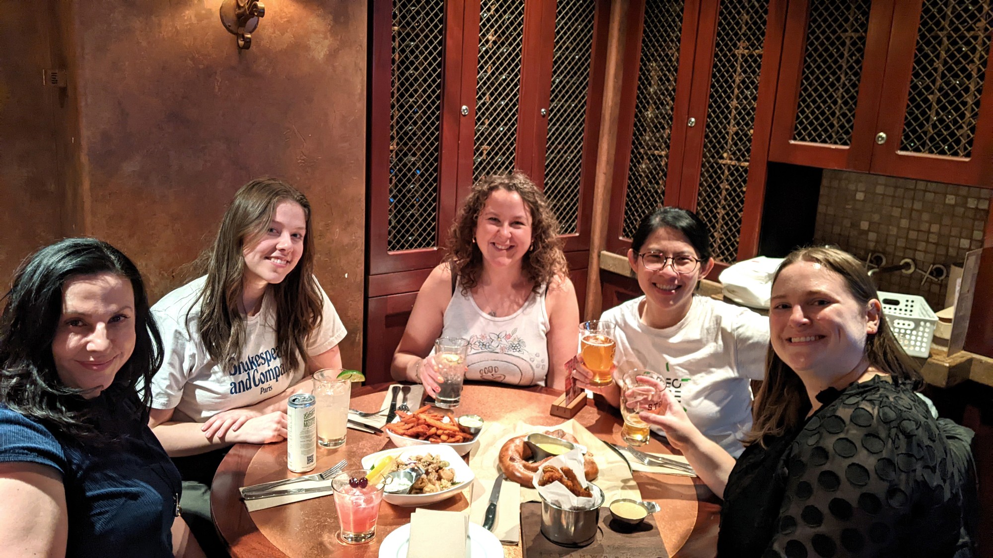 Graduate students take a selfie at dinner in a restaurant