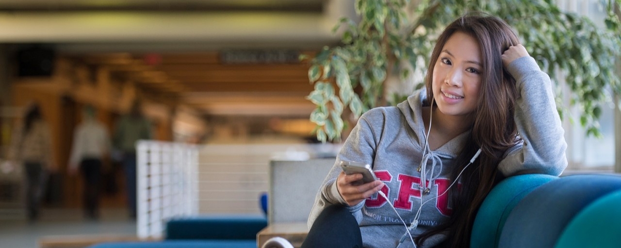 SFU student listening to music in library