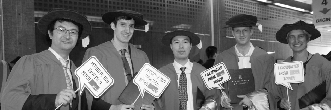 PhD students holding signs 
