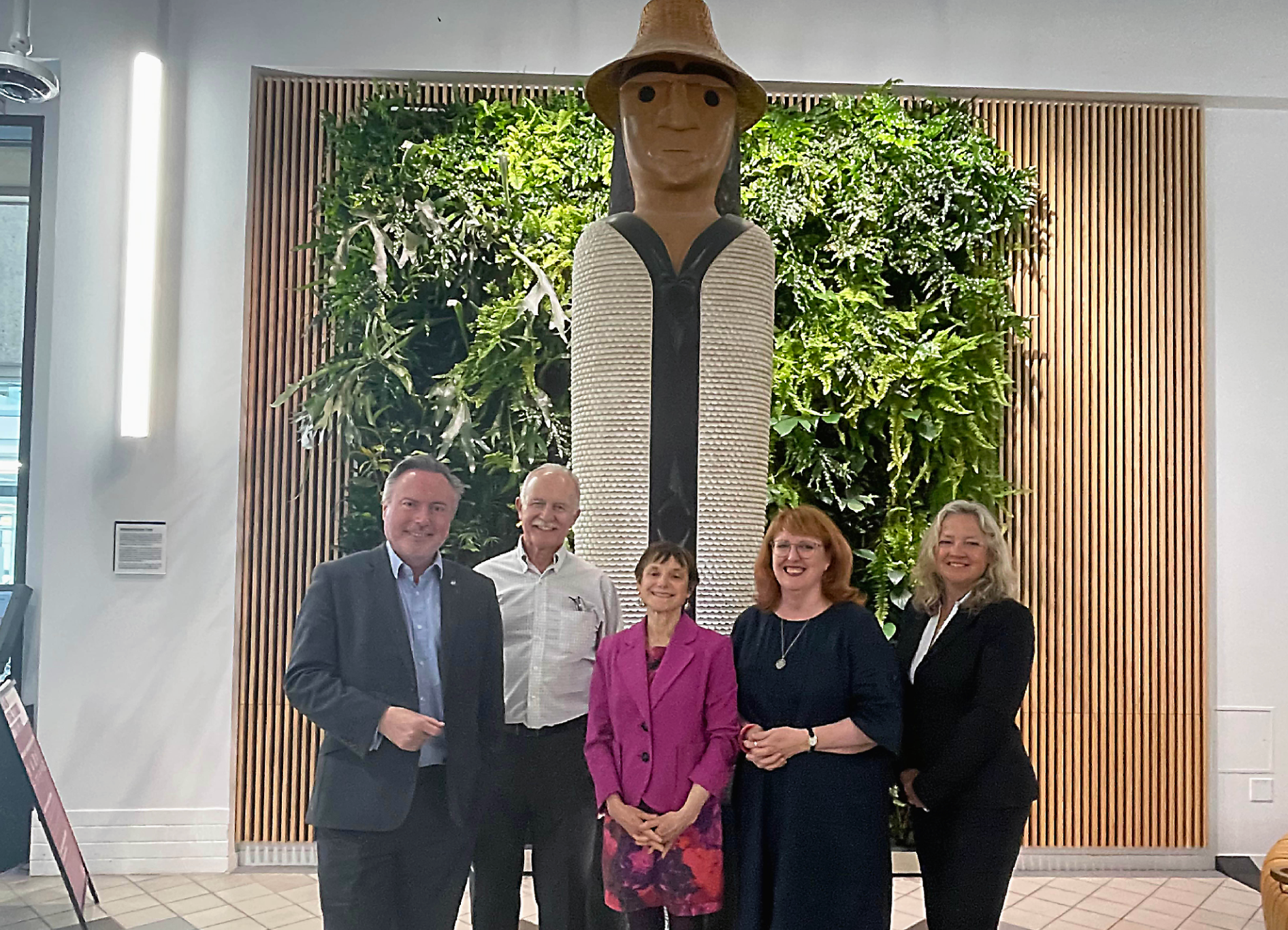 Alyn Smith, Laurie Anderson, Leith Davis, Deidre Brock, and Laurel Weldon in front of an Indigenous carving at SFU Harbour Centre