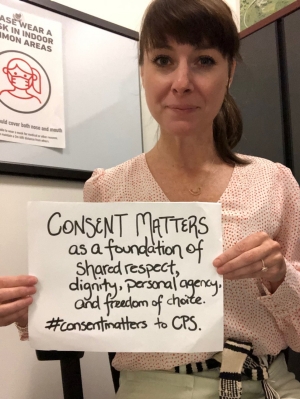 A person holding a sign that reads " “Consent matters as a foundation of shared respect, dignity, personal agency, and freedom of choice. #consentmatters to CPS”