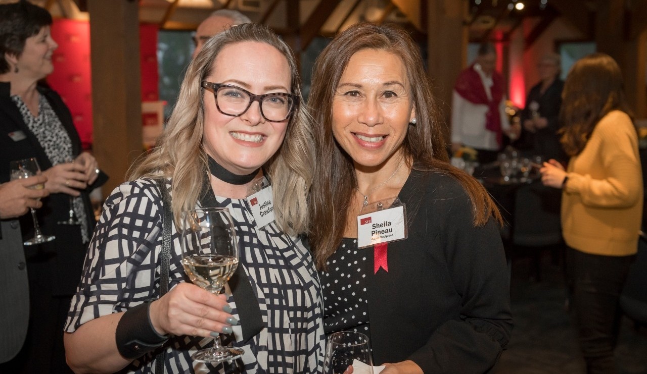 Staff Achievement Award winner Sheila Pineau (right) poses with Justine Crawford (left) at the SFU Awards Dinner on March 5, 2020.