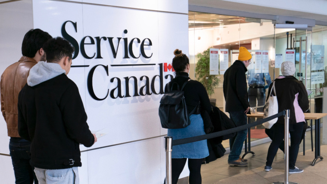 Image of people lined up outside of Service Canada