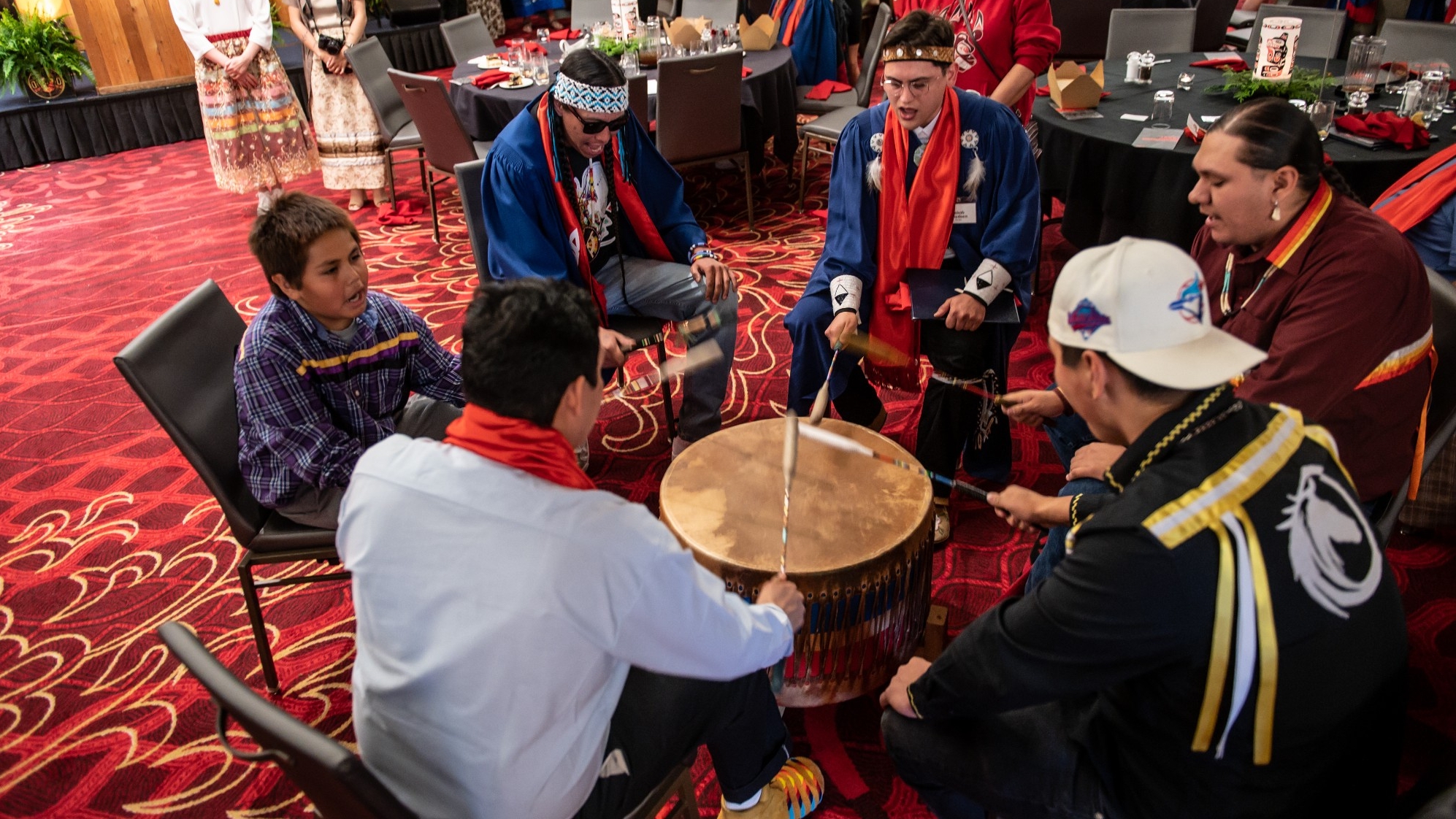 Medicine Creek Drum Group playing the big drum and singing at the Honouring Feast 2022