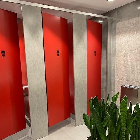 Red stall doors in washroom 1300