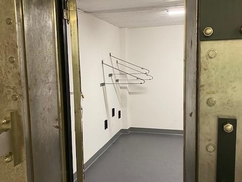 Small, enclosed room with bike racks on wall