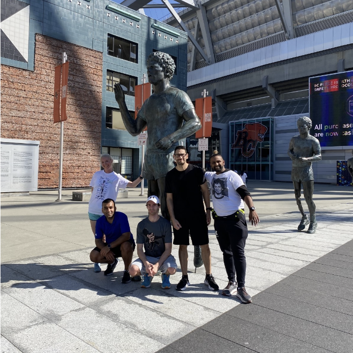 Terry Fox walking and running groups take photos at the Terry Fox statues located at BC place, midway through their 2.5km walk or 5km run