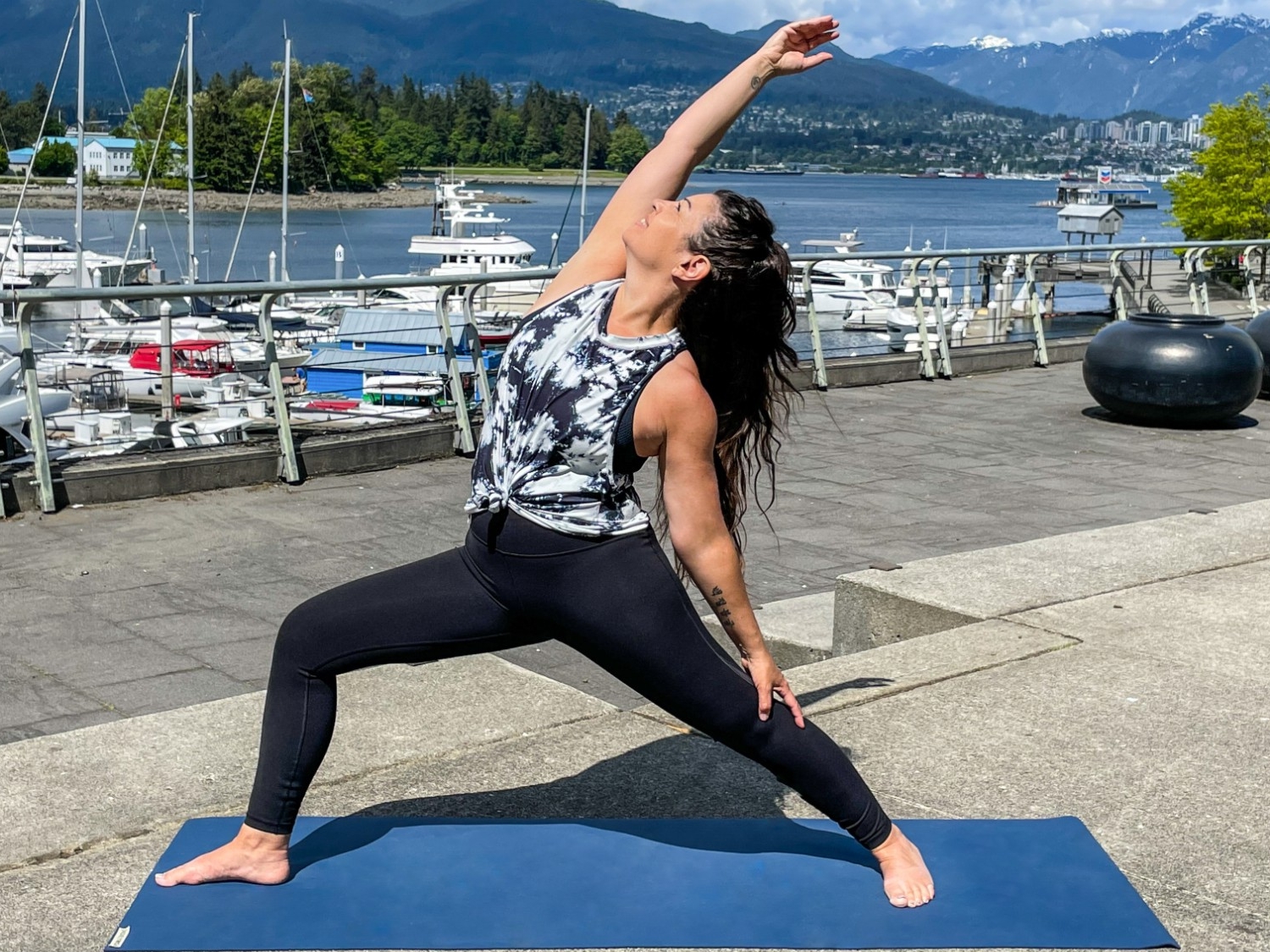 Wellness Class instructor, Pamela Ferman, practicing yoga outside along the Vancouver Seawall