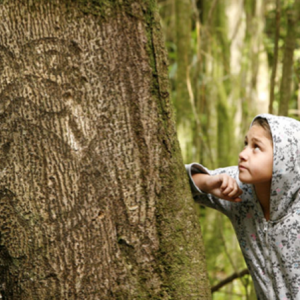 Moriori descendant, Nicole Whaitiri with a rākau momori (living tree carving) on