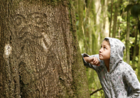 Moriori descendant, Nicole Whaitiri with a rakau momori (living tree carving) on