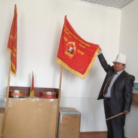 project team member and school principal, Zamir, with school flag. 