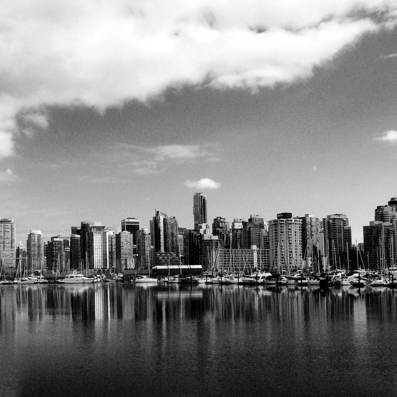 A skyline photo of Vancouver with the ocean