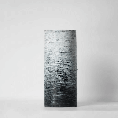 a black and white blended cylindrical vase.