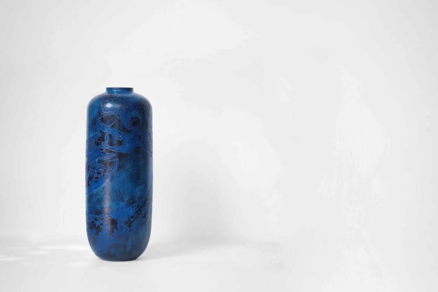 A tall rounded deep blue vase.