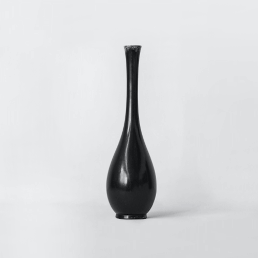 a tall black thin-neck vase.