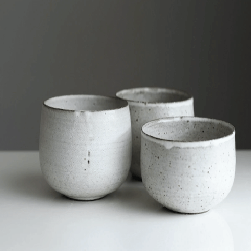 two white ceramic bowls stacked together.