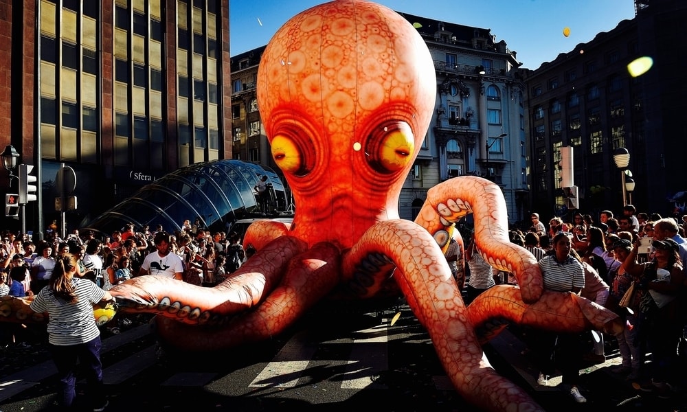 A giant inflatable octopus in the middle of a crowd