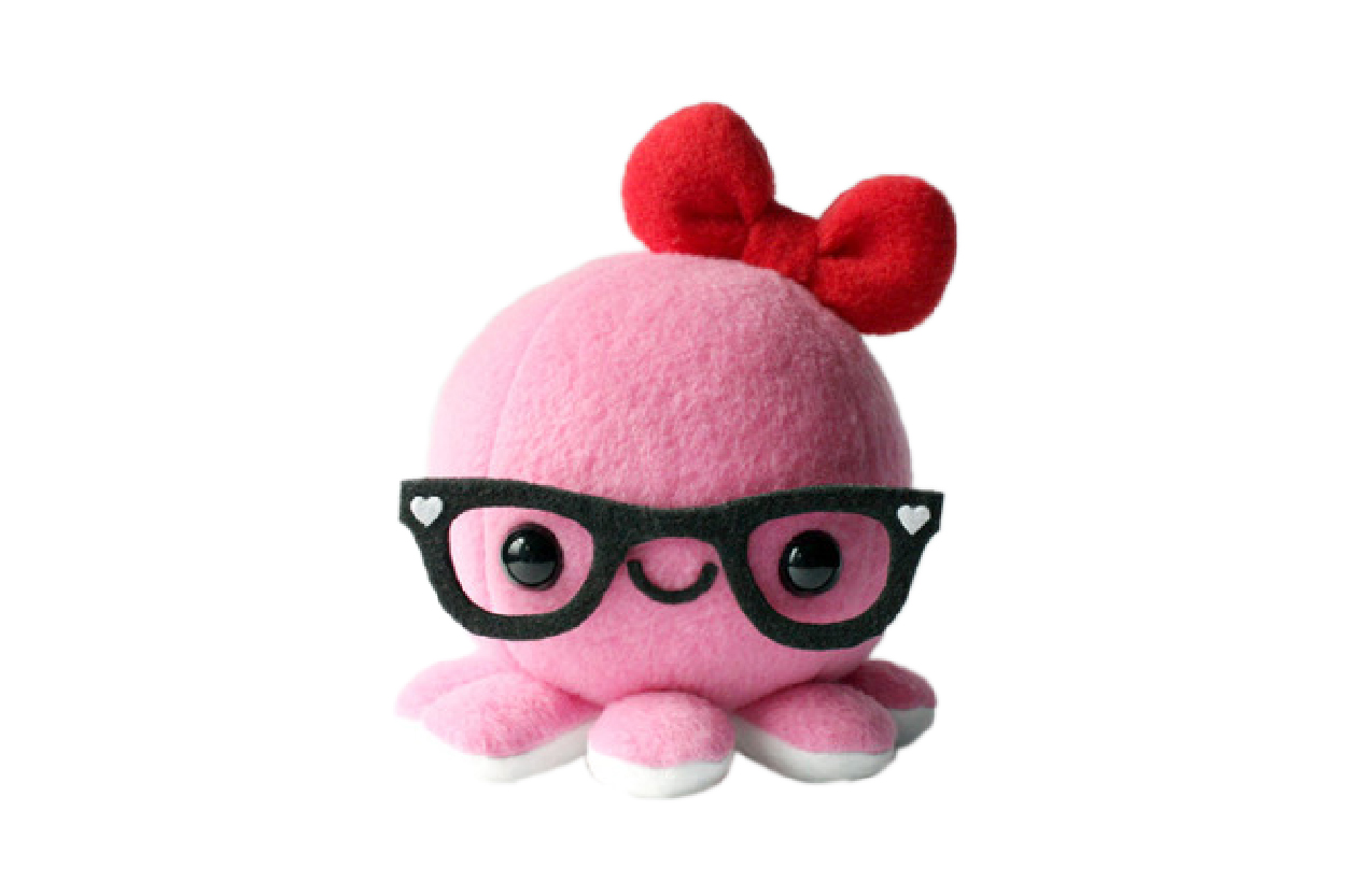 A pink octopus plush with black glasses and a red ribbon on top of its head