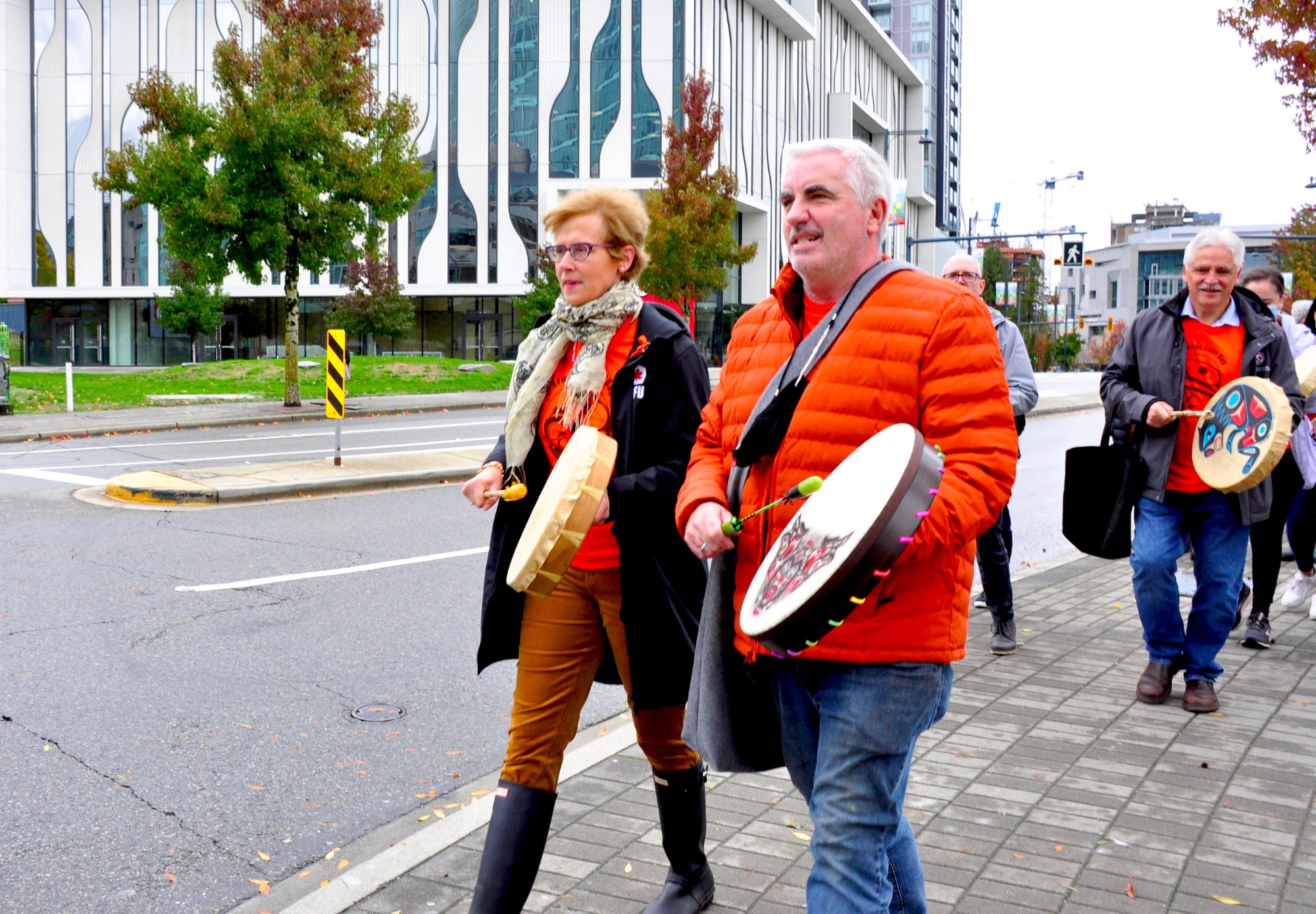 SFU President Joy Johnson and Surrey campus Executive Director Steve Dooley joined a drumming procession from Surrey City Hall to Holland Park