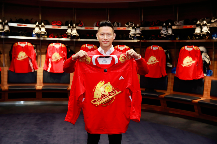 Trevor Lai holding the Lunar New Year jersey