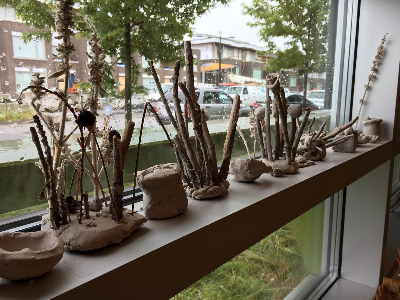 Clay and branches sitting on a windowsill
