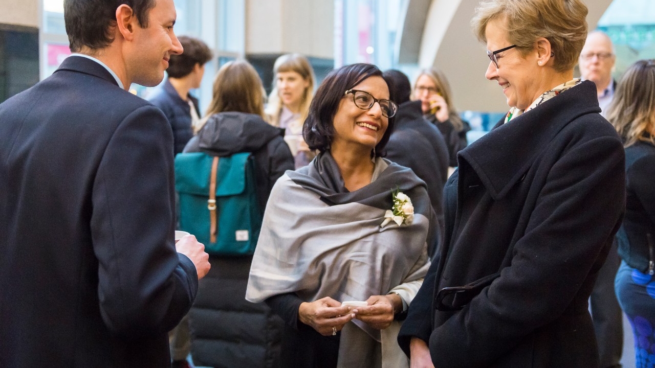 Centre Program Director (Robin Prest) and SFU President (Joy Johnson) speak with guest during reception at the Jack P. Blaney Award for Dialogue event.