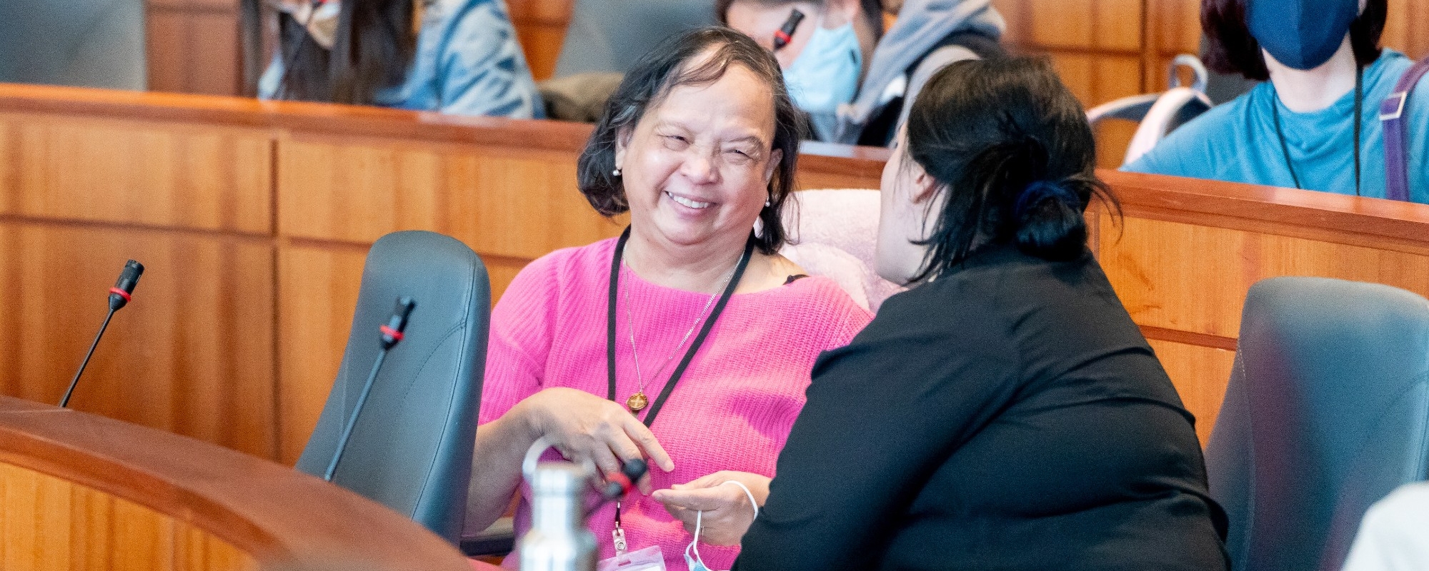 Two participants are seen chatting and smiling during a dialogue at the Asia Pacific Hall.