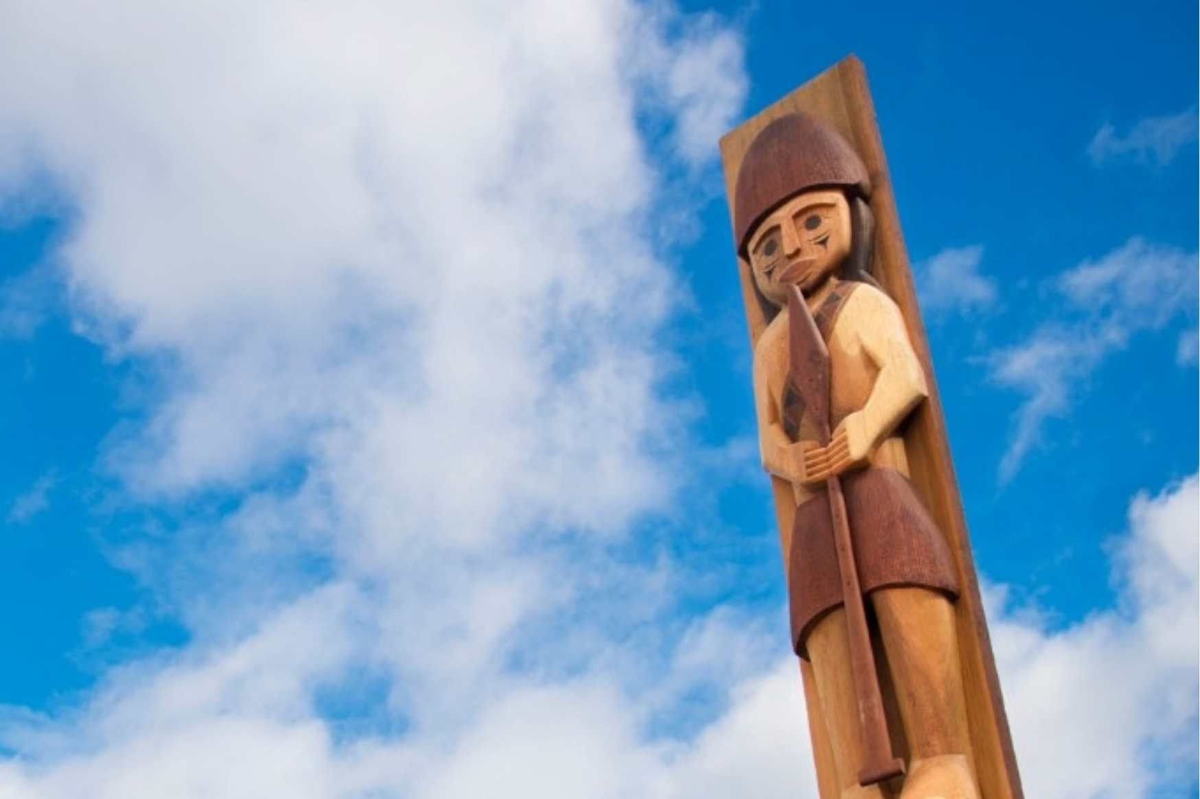 Indigenous Totem Pole in front of a blue sky