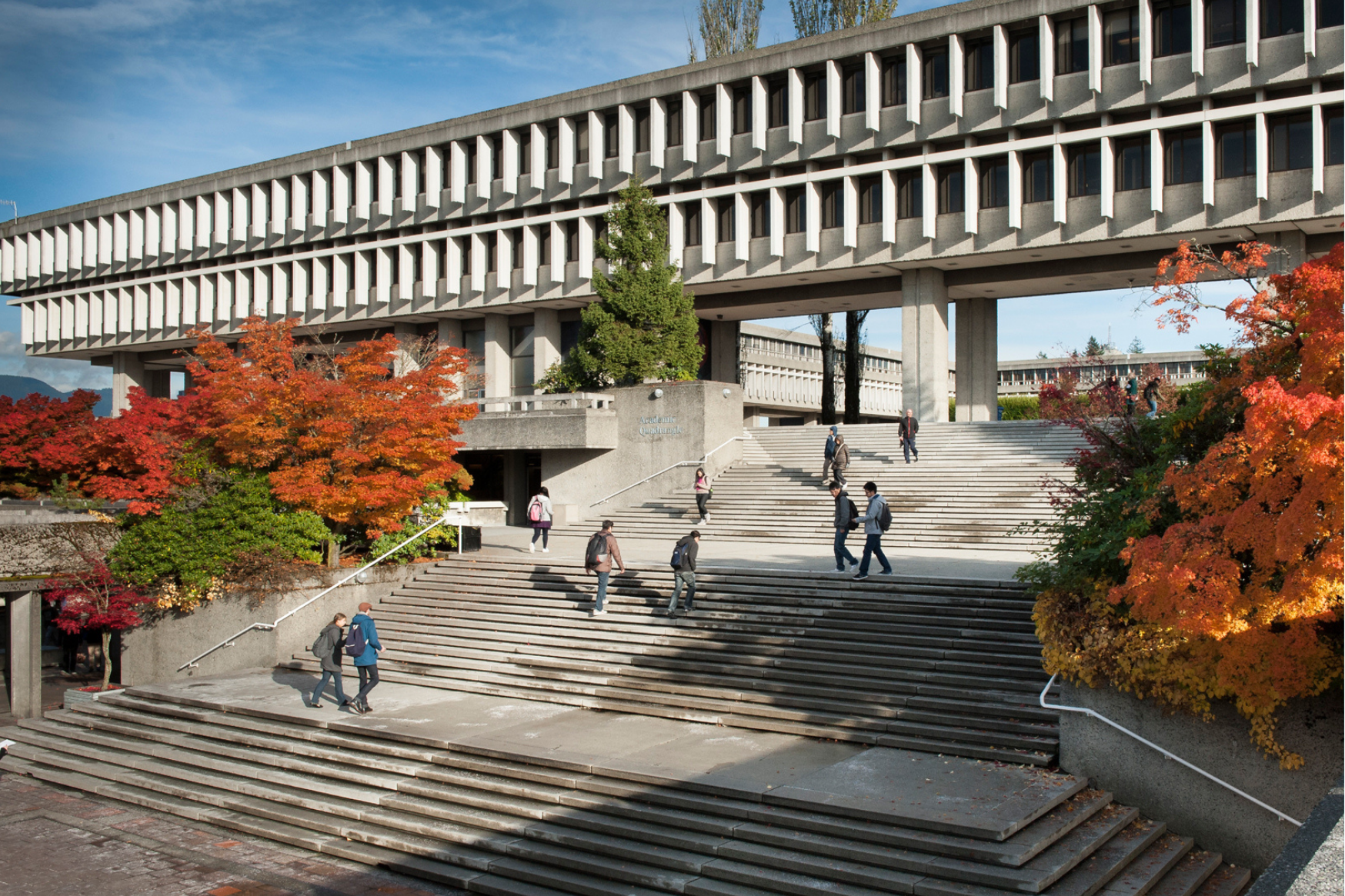 Bird's eye view of SFU's AQ building with people walking up the stairs.