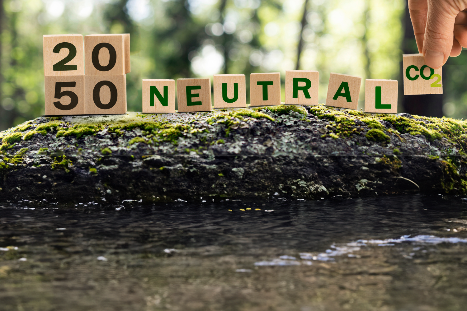 Scrabble letters spell out 2050 NEUTRAL CO2 on a log in nature, AI generative fill has extended the foreground to include a stream
