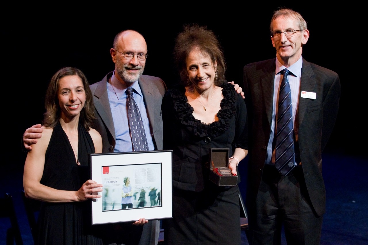 Liz Lerman posing with her award and distinguished guests