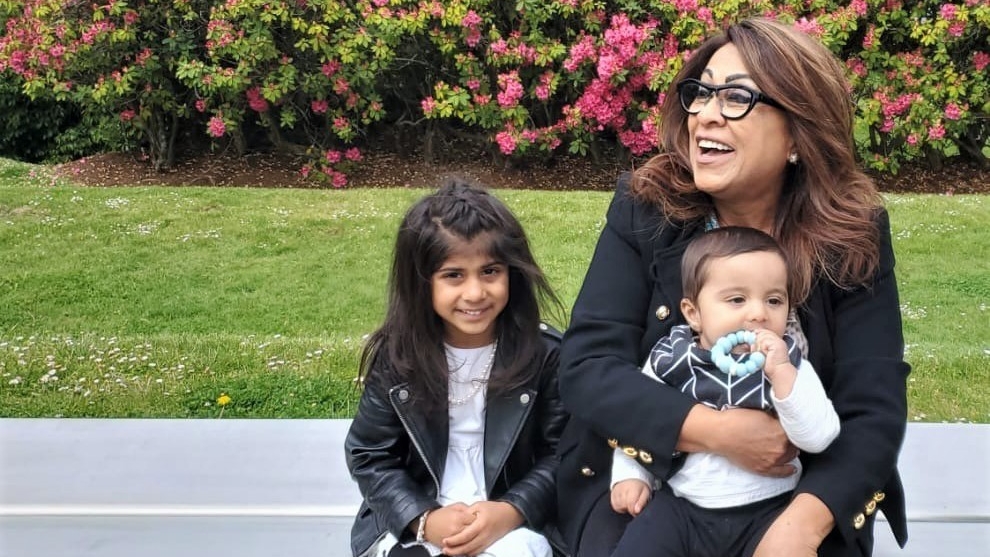 Rozy Karim with her grandchildren, Arya (L) and Liyam (R), says attending SFU was her childhood fairy tale dream come true.