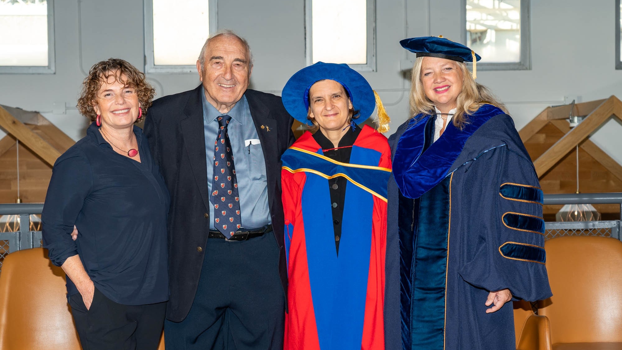 A group photo of Economics Department Chair Anke Kessler, donor Wilson Parasiuk, honorary degree recipient Esther Duflo, and FASS Dean Laurel Weldon