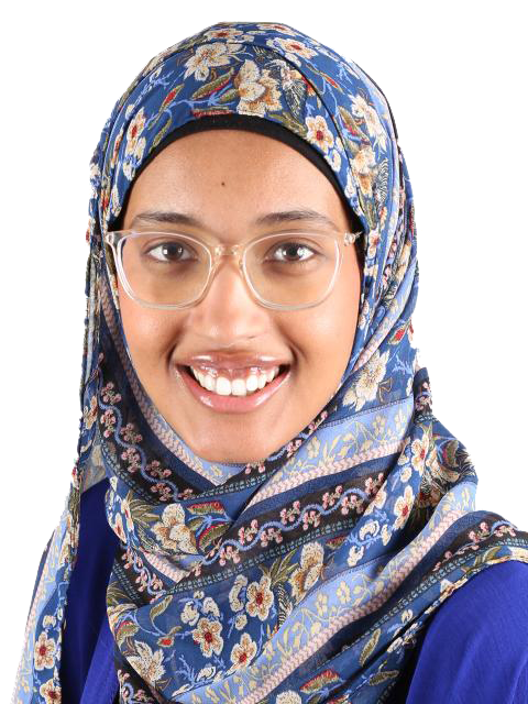 A portrait of Balqees wearing a blue floral hijab and wears clear framed glasses.