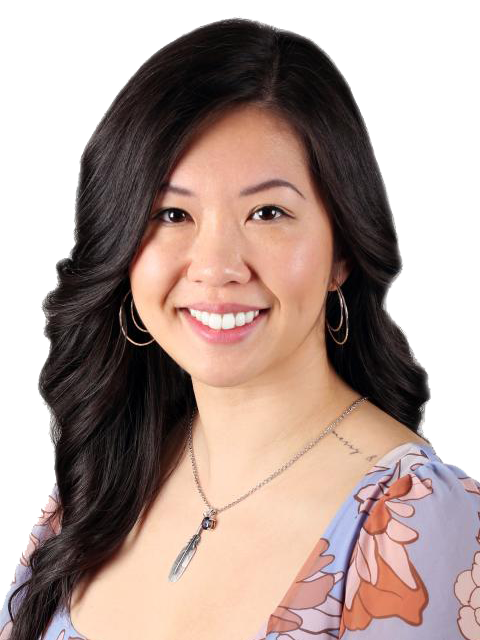 A portrait of Christina. She has long black hair and is wearing a purple floral shirt.