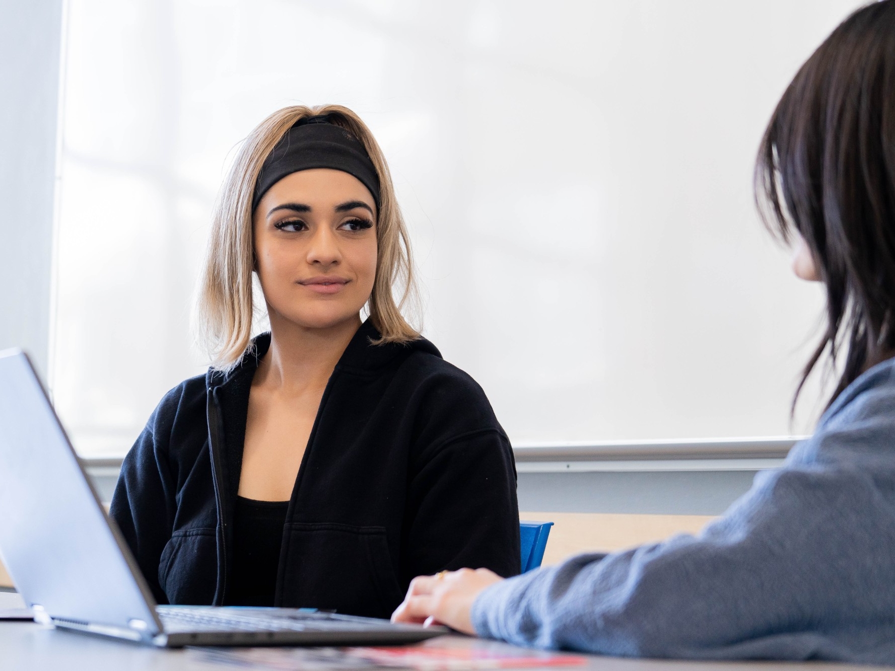 Student sits with an academic advisor at SFU Surrey campus