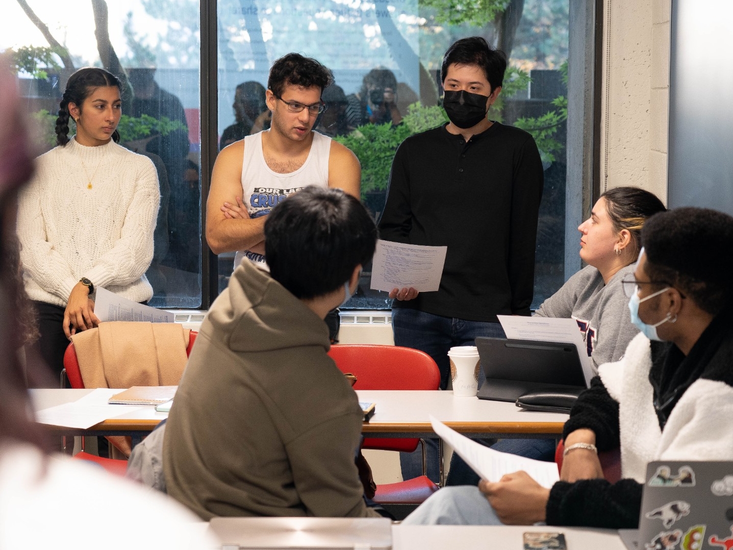 Students discussing a group presentation in class